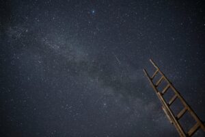 A wooden ladder under a star-filled night sky, ideal for astronomy enthusiasts.