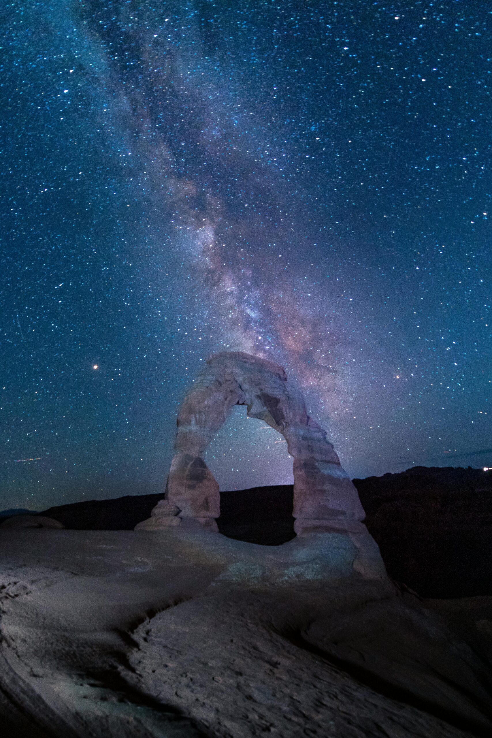 Stunning night sky view with the Milky Way over Delicate Arch in Arches National Park, Utah.