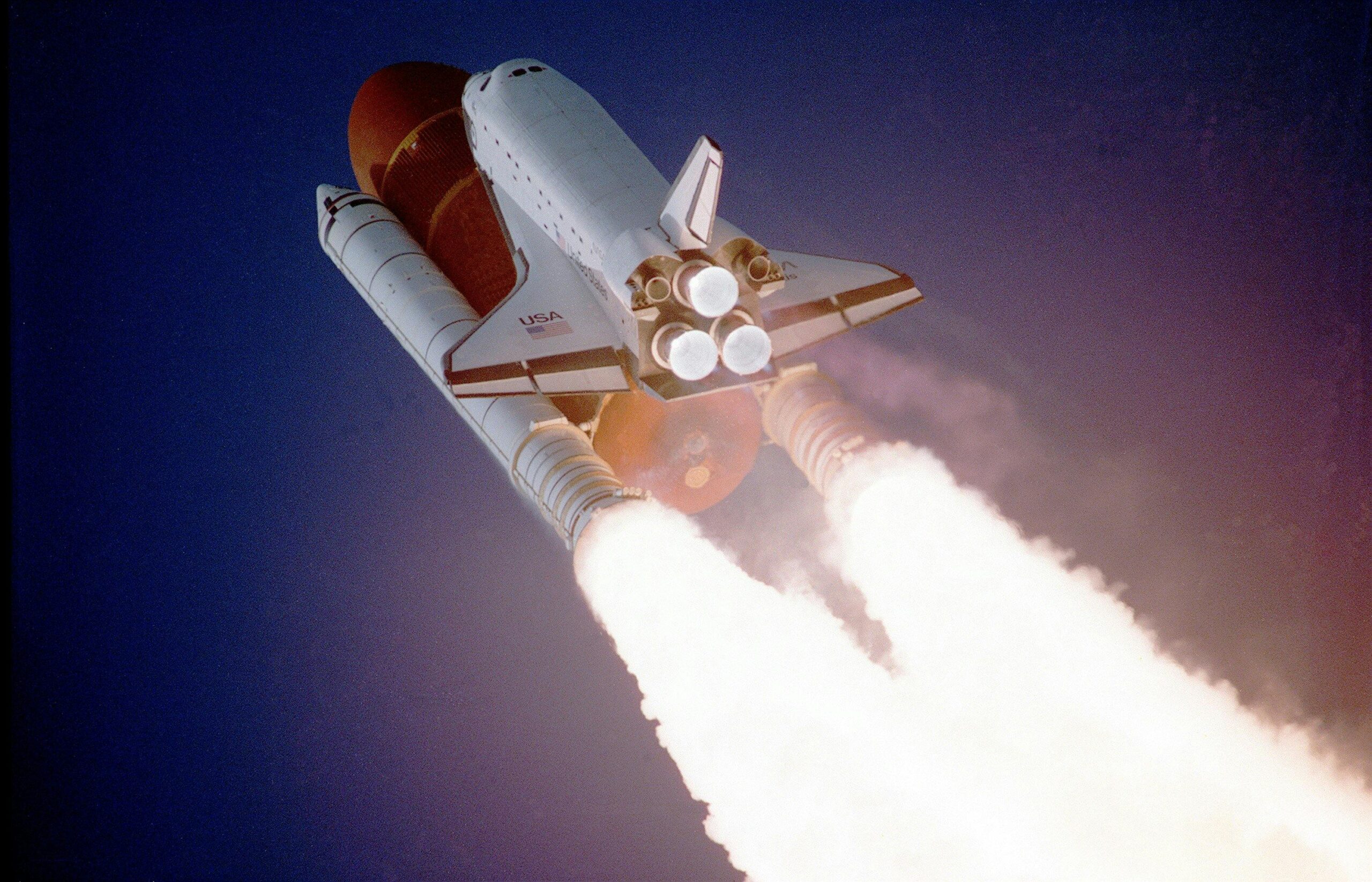 A space shuttle launches into space, showcasing powerful rocket engines and USA branding.