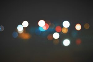 An artistic bokeh effect of colorful city lights creating a soft, dreamy atmosphere.